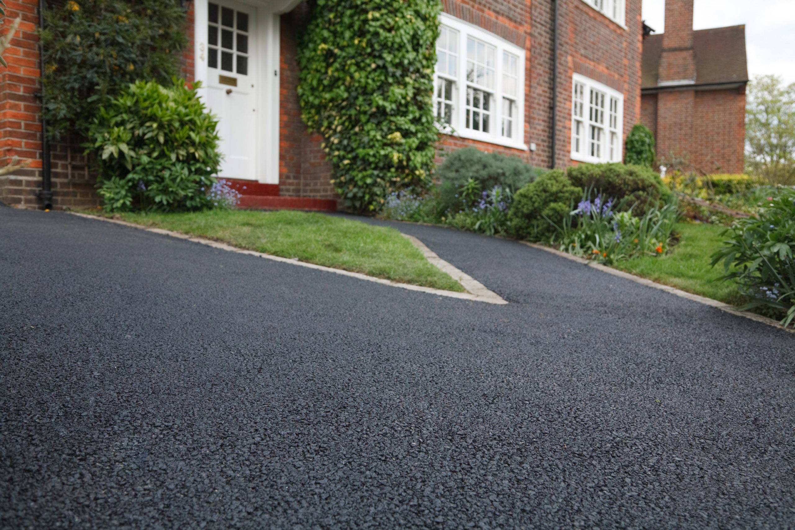 Newly finished tarmac driveway outside a brick house near Exeter